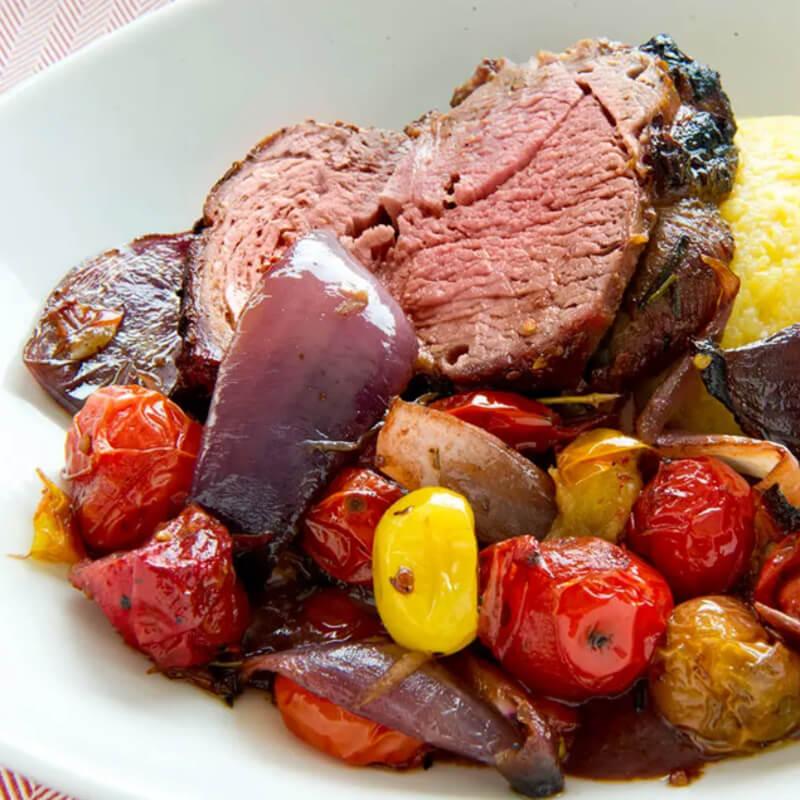 https://aicdqu4q.cdn.imgeng.in/Kalamazoo/media/Images/spit-roasted-leg-of-lamb-over-grits-and-tomatoes.jpg