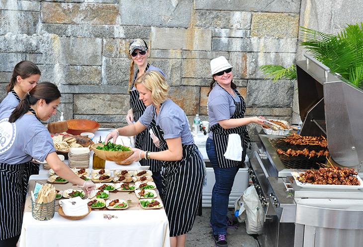 Saveur Summer BBQ - Saveur test kitchen team cooking on a Kalamazoo Grill