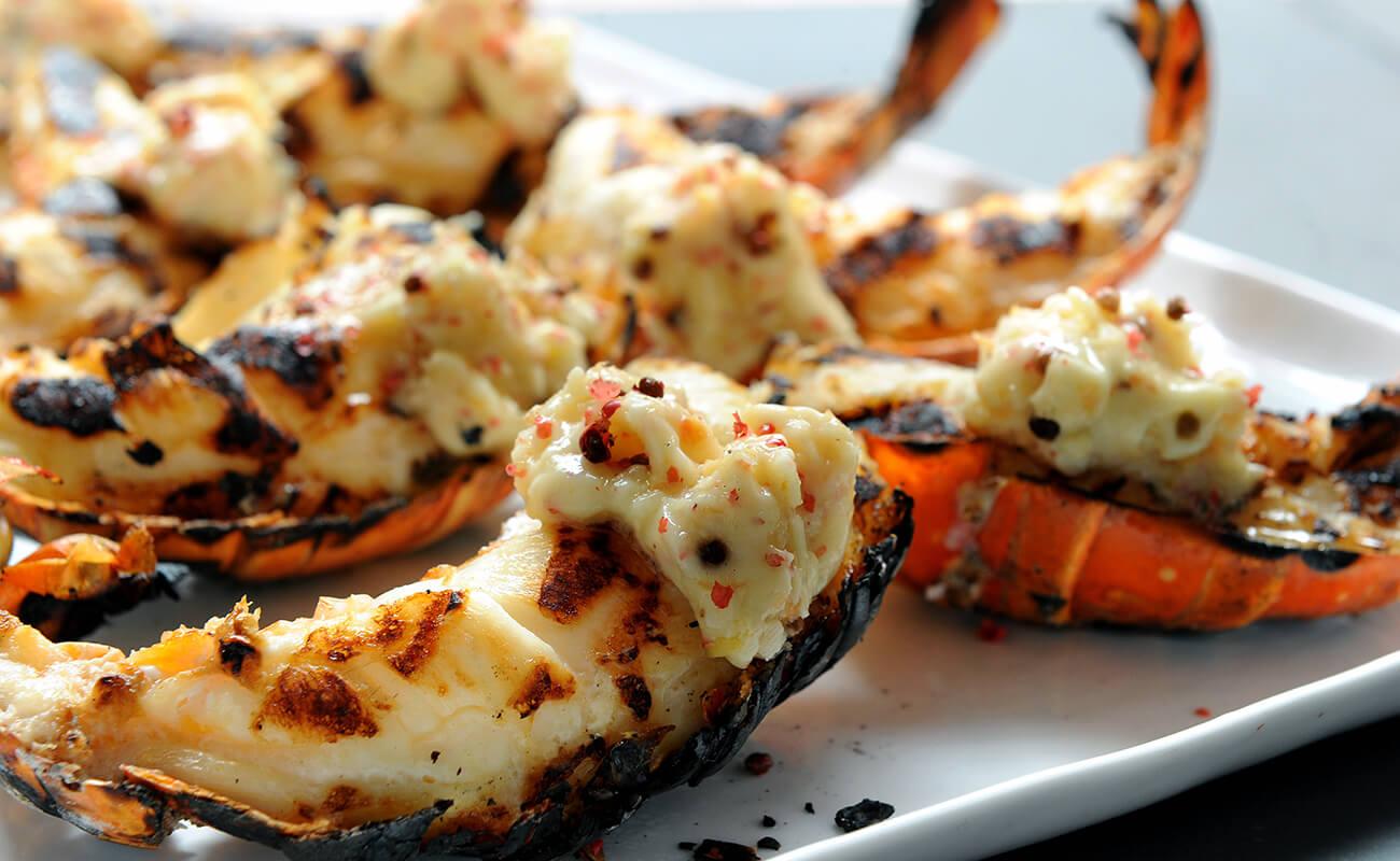 Image of Grilled Lobster Tails with Ginger Grapefruit and Pink Peppercorn Butter